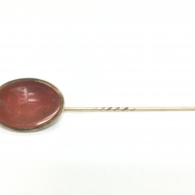 A gold stick pin with intaglio cut agate mount. Shipping category A.