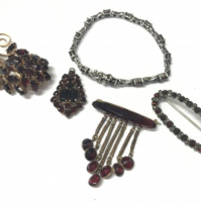 A silver garnet bracelet and brooch, plus two garnet brooches and a pendant . Postage category A