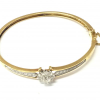 An 18ct gold Edwardian diamond bangle. 18.71g and approximately 6.5cm diameter. Postage B