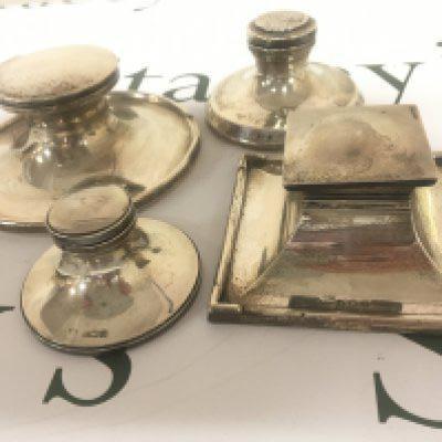 Four Silver Capstan type silver ink wells one of square shape with Birmingham 1921 hallmarks and three round ink wells (4)