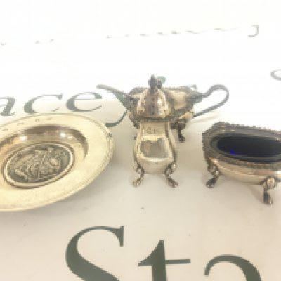 A silver dish London Assurance and a three piece silver condiment set.