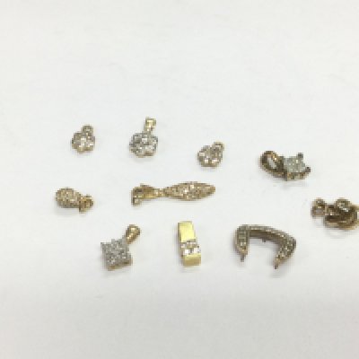 Ten gold diamond cluster pendants, total approx 6.3g. Shipping category A.