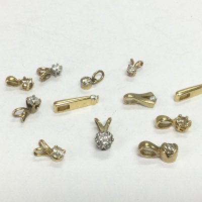 Twelve gold solitaire diamond pendants, total approx 5.8g. Shipping category A.