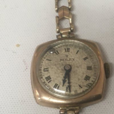 A Vintage ladies 9carat gold cased Rolex watch with a 9carat gold strap attached possibly a replacement movement sold as seen weight 16g approximately.