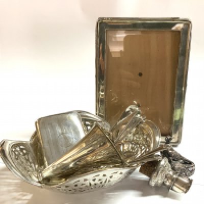A hallmarked silver basket, Silver photo frame, Hallmarked silver wine bottle pourer, Silver overlaid pheasant, cutlery.