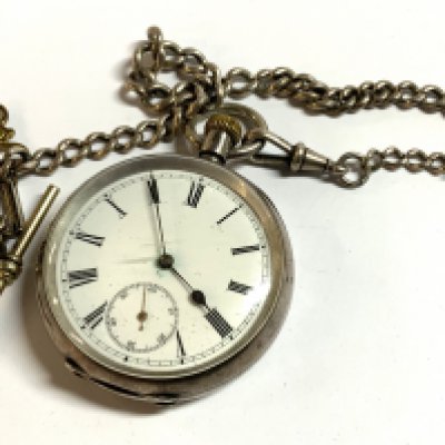 A hallmarked silver pocket watch with attached part silver Albert chain.