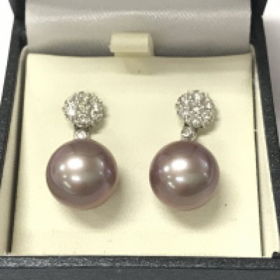 A pair of 18ct white gold earrings set with large pinkish grey pearls with detachable diamond daisy bales. Postage B