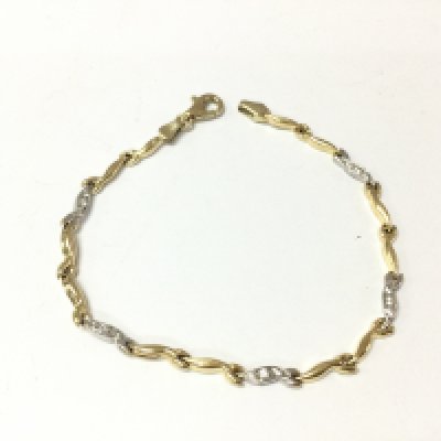 A 14ct gold bracelet. Yellow and white gold with white stones. 4.47g