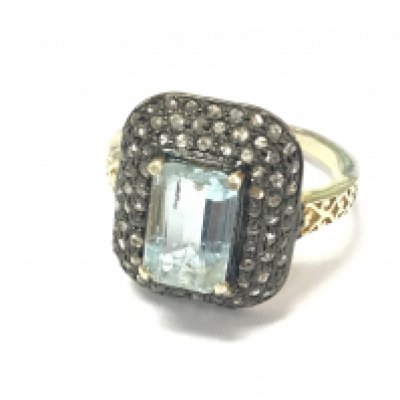 A vintage style aquamarine and diamond ring with hand carved design in silver gilt. Emerald cut aquamarine 2.10ct and diamonds 0.72ct. Size P