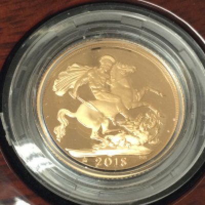 A 2018 gold proof sovereign with box and COA.