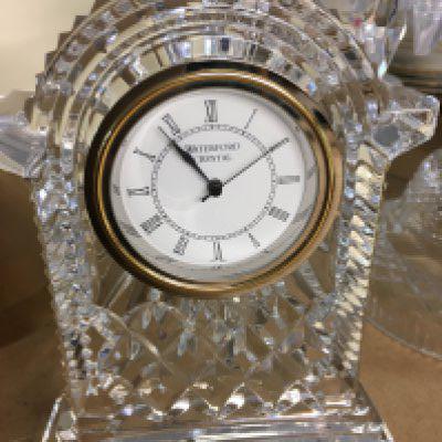 A Waterford Crystal clock together with a Baccarat style candelabra and a cut glass table lamp .
