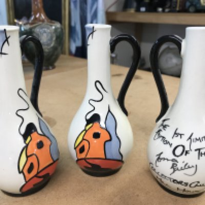 Three Lorna Bailey pieces with the words "The 1st Limited Edition of The Lorna Bailey Collectors Club Hill House" on each of the small jugs. Each 14cm in height