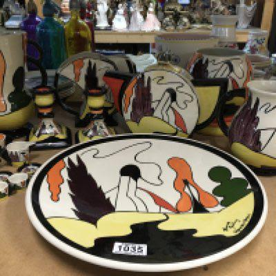 A collection of Lorna Bailey pottery in the "House and Path" range, to include charger, tea pot, two vases, two jugs, pair of candlesticks and a miniature tea set