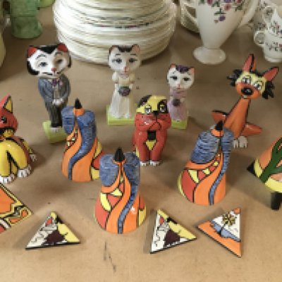 A collection of various Lorna Bailey pottery, including Cat Bride and Groom, other animals, triangle brooches and Sugar Shakers