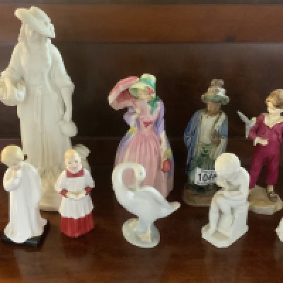 A small collection of porcelain figurines to include Worcester, Doulton Lladro etc.
