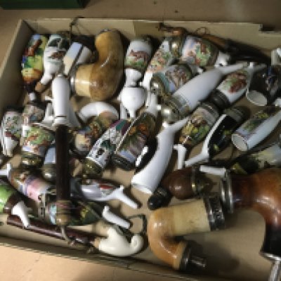 A Collection of porcelain pipes decorated with various country side scenes.