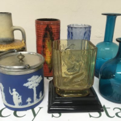 A collection of ceramics and glass an Early 20th century Wedgwood biscuit barrel German pottery mid 20th vase one other glazed pottery vase and art glass.