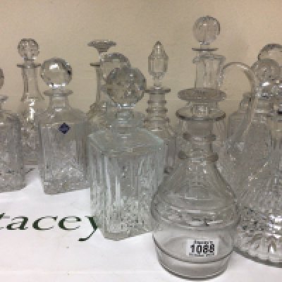 A good collection of cut glass decanters including a late George III decanter with a mushroom. Edinburgh Crystal and many others.