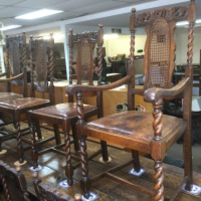 Six oak dining chairs and two carvers with carved top rails and barley twist supports. Shipping category D.
