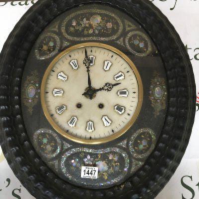 A Continental wall clock inlaid with mother of pearl and with a white marble dial with raised and applied enamel numerals. Case length 59cm