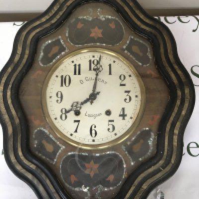 A Continental late 19th century wall clock the case inlaid with mother of pearl and specimen woods the dial with the inscription O Gilbert Lusignan case size 61cm