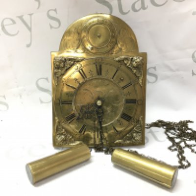 A German brass wall clock with weights . Postage category C- NO RESERVE