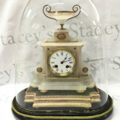 An Alabaster mantle clock with gilt mounts under dome. With key and pendulum .Clock 29cm tall 22.5cm wide. Dome 40cm tall.