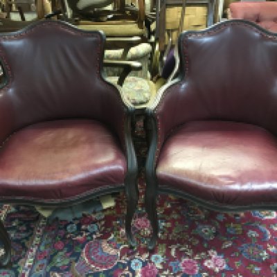 A pair of red leather upholstered tub chairs , 94cm tall 62cm wide