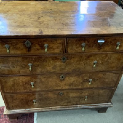 A George II walnut veneered chest of drawers. Replacement fittings and feet 102cm x 97cm x 57cm
