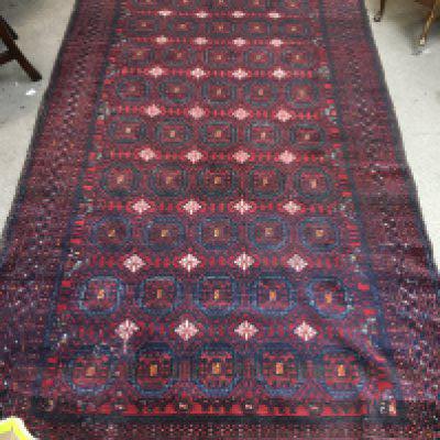 A Persian wool rug. Approx size 143x247cm.