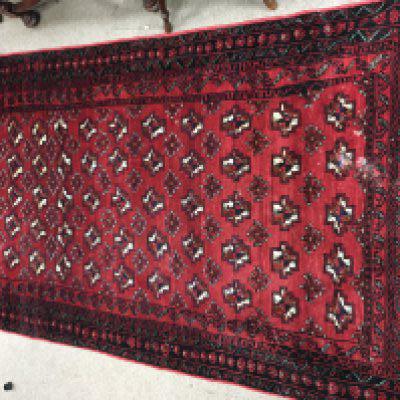 A Persian wool rug. Approx measurements 110x184cm