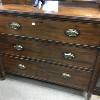 A mahogany Regency style chest of drawers. The rectangular top above three drawers, flanked by pillar supports. 100cm x 52cm