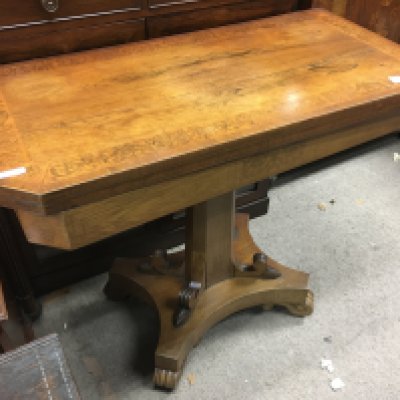 A Victorian walnut card table, the inlaid twin flat top above a shaped colour non a plinth base