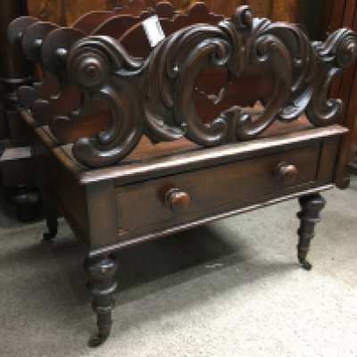 A Victorian mahogany Canterbury with three open sections, fitted with a single drawer on turned legs