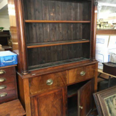 A Victorian open bookcase above two drawers and cupboards under. On bracket feet