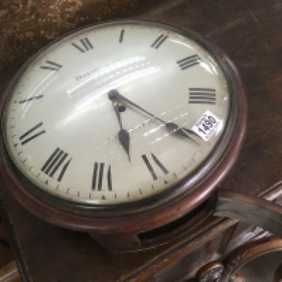 A mahogany drop dial wall clock, with fuse movement. The painted dial with Roman numerals. 32cm across
