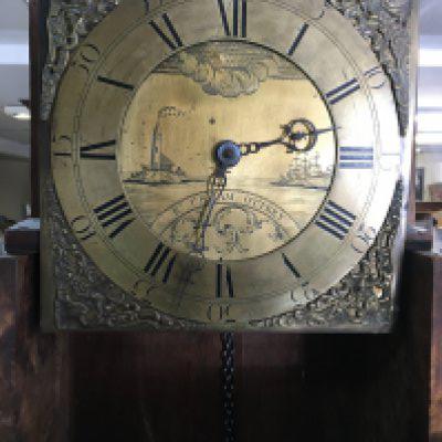 An oak 30 hour long case clock having brass dial with Roman numerals