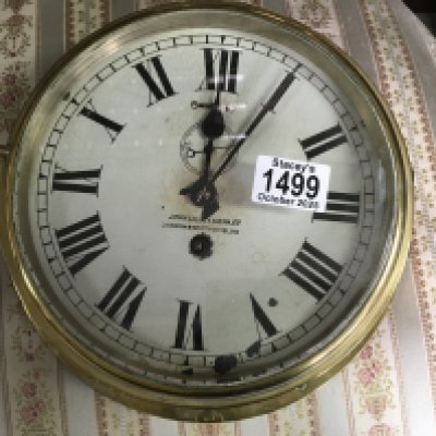 A brass bound ships clock, the dial having Roman numerals. 26cm across