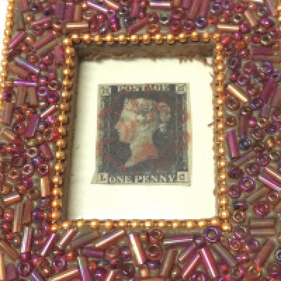 A framed penny black stamp. Postage category A