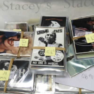 A box containing various vintage postcards including music, trains , locations etc