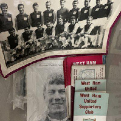 West Ham Football Memorabilia Box: Large box containing photos, handbooks, 2 programme binders, puzzle, signed John Lyall book, menus including 2 signed, scrapbook, cuttings, replica shirt and much more.