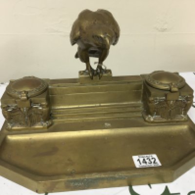 An Art Deco desk top pen tray and inkwell The ink well surmounted with a solid cast Eagle flanked by ink wells. Width 35cm
