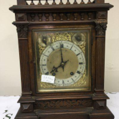 An Edwardian walnut cased mantel clock the case with a gallery above half pilasters silvered chapter ring dial with S Smith & Son Ltd Strand London. With strike silent subsidiary dial key and pendulum 44cm heigh