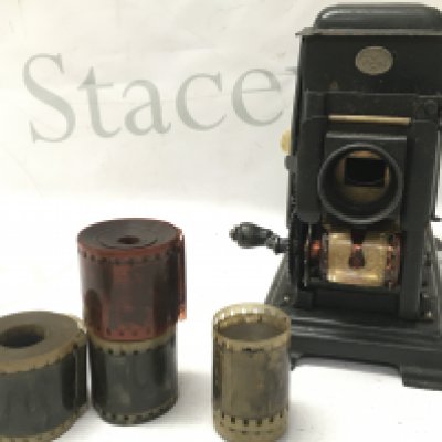 Vintage German lantern hand operated film projector with some reels . Most appear to be military marches. No reserve . Postage cat b