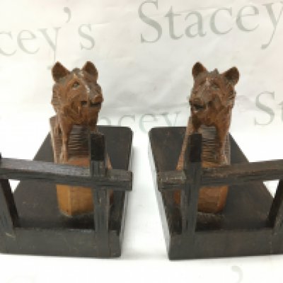 A pair of black forest carved book ends in the form of wild boars ,19.5cm tall 24cm wide . Postage cat C