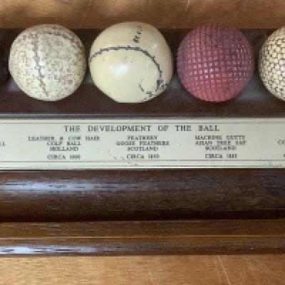A novelty pen stand. The Development of the ball. (Golfing)