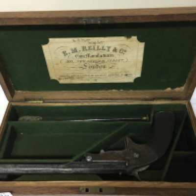 A Victorian single Target Pistol maker E M Reilly & Co New Oxford Street London the pistol with an octagonal barrel engraved with EM Reilly & Co maker patent stamp 1758. With a nice original oak fitted box with cleaning rod. .320 caliber. Stamped on the barrel breech load. Total length 28cm scratches to the barrel A FIREARMS LICENSE IS REQUIRED TO BUY THIS LOT VIEWING AND COLLECTION BY APPOINTMENT ONLY.