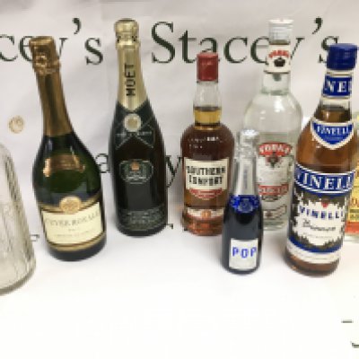 A collection of various bottles of alcohol including gin vodka champagne etc.