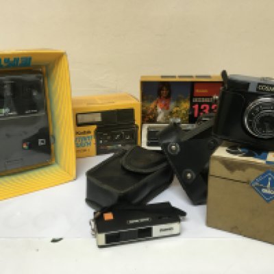 A collection of Vintage cameras boxed and as new Kodak Instamatic 133 Kodak EK160 instant flash Model C a Cosmic 35 with box and other cameras.