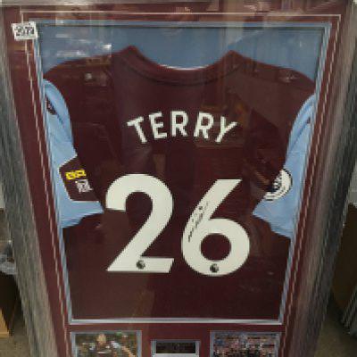 A framed and signed John Terry Aston Villa F.C shirt. Frame size 67x96cm.